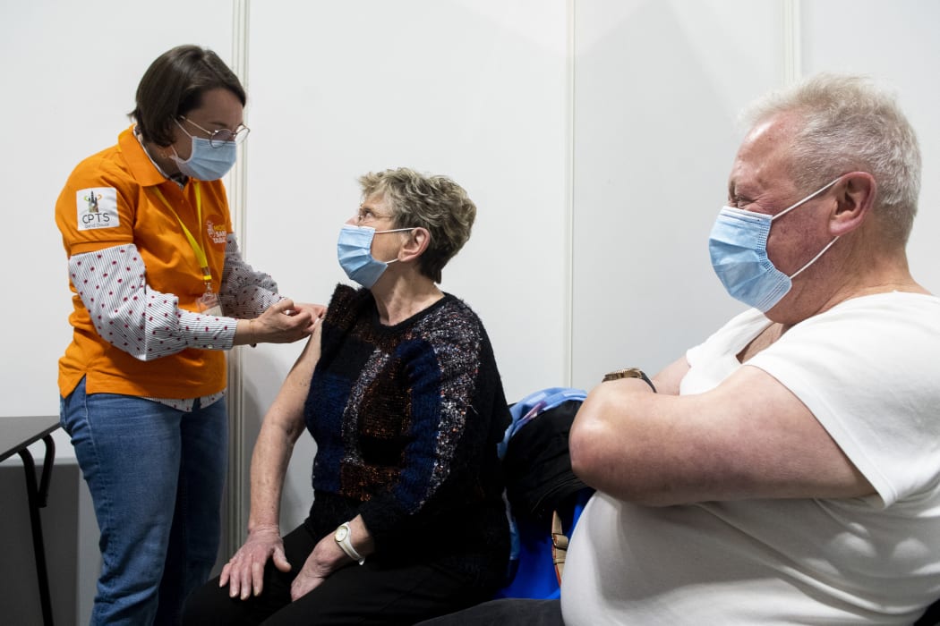 A caregiver giving an intramuscular injection of PFIZER vaccine during a mass vaccination campaign at gayant expo in Douai in France.