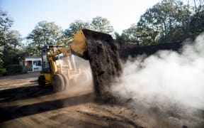 Front loader working with organic compost production