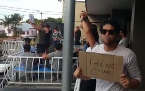 Refugees protest at their Brisbane hotel.