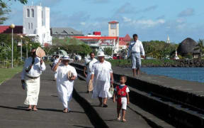 Samoans walking on the waterfront in Apia
