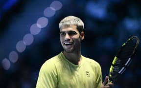 Spain's Carlos Alcaraz reacts during the match against USA's Taylor Fritz during the ATP Finals tennis tournament in Turin on November 11, 2025. (Photo by Marco BERTORELLO / AFP)