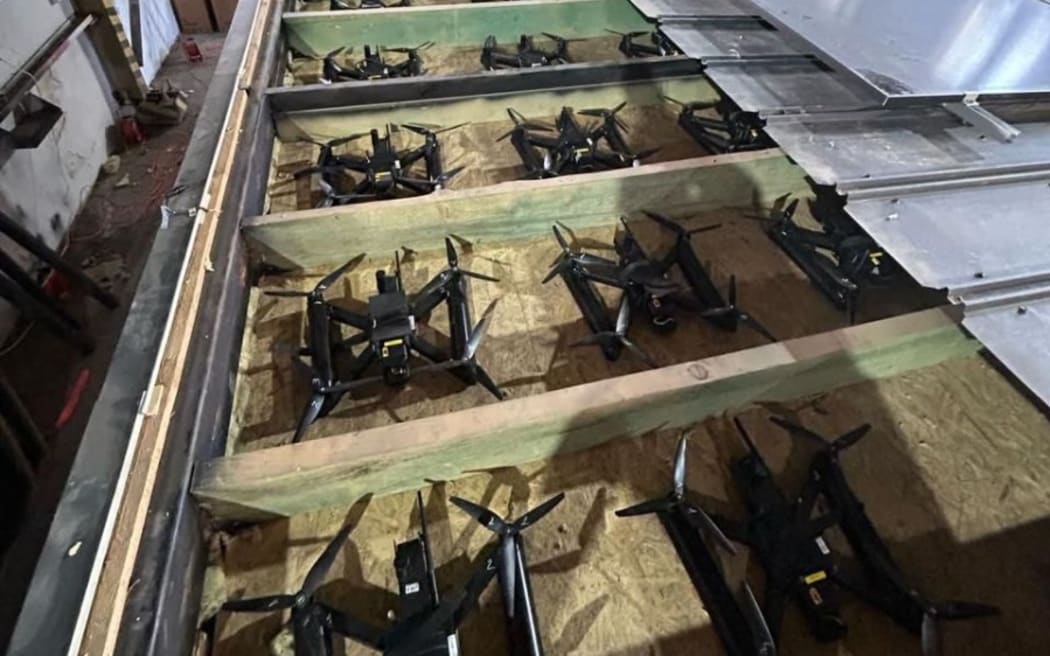 This undated and unlocated handout picture, released on June 1, 2025 by the Security Service of Ukraine shows Ukrainian military drones, amid the Russian invasion of Ukraine. Ukraine said on June 1, 2025 it launched a "large-scale" attack against Russian military aircraft on the same day, hitting a base in eastern Siberia thousands of kilometres (miles) from its border, a source within the Ukrainian security services said. "Ukrainian security services are carrying out a large-scale special operation aimed at destroying enemy bombers far from the front, in Russia," the source said, adding more than 40 aircraft had been hit and a fire broke out the targeted Belaya air base, in eastern Siberia. (Photo by Handout / SECURITY SERVICE OF UKRAINE / AFP) / RESTRICTED TO EDITORIAL USE - MANDATORY CREDIT "AFP PHOTO / SECURITY SERVICE OF UKRAINE" - NO MARKETING NO ADVERTISING CAMPAIGNS - DISTRIBUTED AS A SERVICE TO CLIENTS