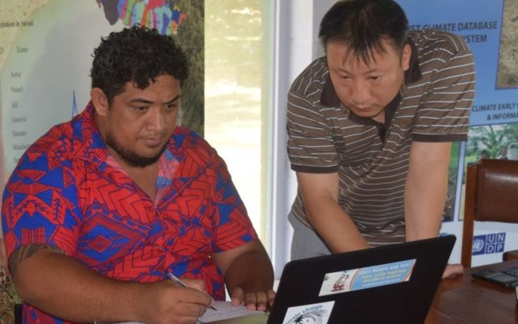 Principal Scientific Officer, Tile Tofaeono running the Climate Prediction software with team from APEC Climate Center.
