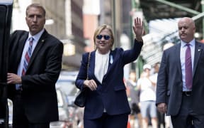Hillary Clinton leaves her daughter's apartment building in New York where she rested after leaving a  9/11 memorial ceremony feeling unwell.