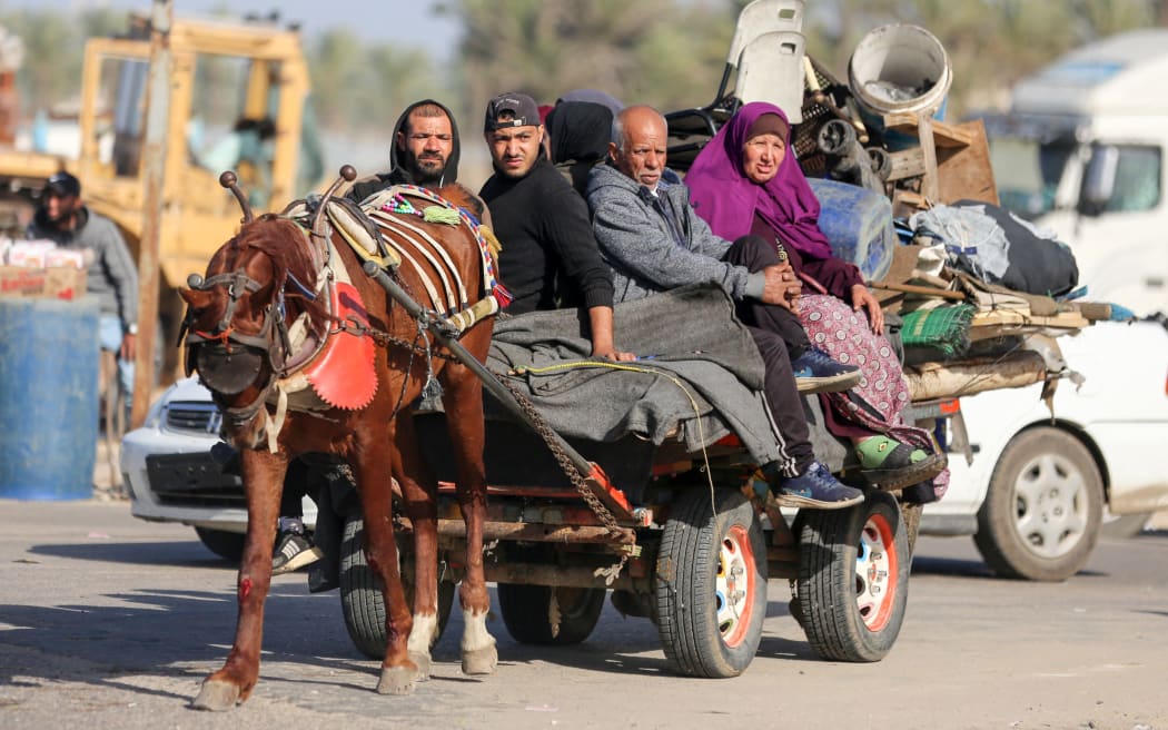 Palestinian families are fleeing the city on the coastal road leading to Rafah from the southern outskirts of Khan Yunis, in the southern Gaza Strip, amid ongoing battles between Israel and the Palestinian militant group Hamas, in Khan Yunis, Gaza Strip, on January 22, 2024. (Photo by Majdi Fathi/NurPhoto) (Photo by MAJDI FATHI / NurPhoto / NurPhoto via AFP)