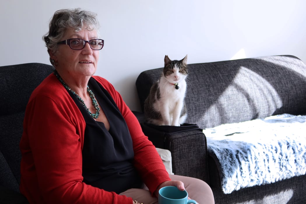 Jenni Schreuder and her cat Bobby in her Vevian Place flat.