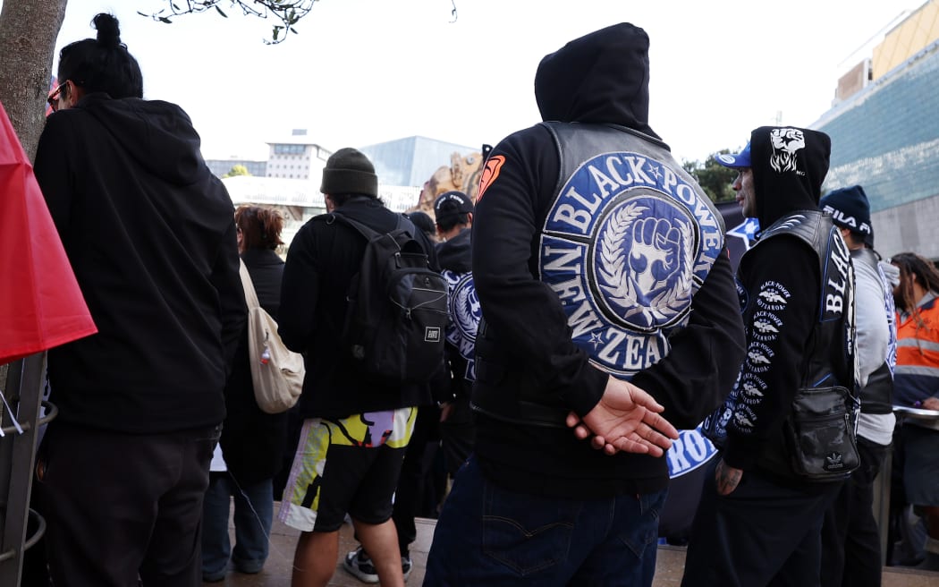 AUCKLAND, NEW ZEALAND - MAY 30: Black Power gang members wearing insignia join a march down Queen St on May 30, 2024 in Auckland, New Zealand. The nationwide day of activation saw Hikoi, or protest marches, take place around the country. Organisers said on Instagram that the action was intended to demonstrate a unified Aotearoa response to the current government's handling of Treaty of Waitangi matters and relationship with New Zealand's Indigenous Maori population. The action co-insided with the presentation of the budget in parliament. (Photo by Fiona Goodall/Getty Images)