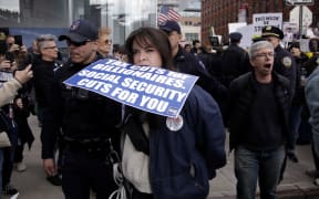 Demonstrators are arrested during a "TeslaTakedown" protest against Elon Musk outside of a Tesla dealership in New York, March 1, 2025. (Photo by Leonardo Munoz / AFP)