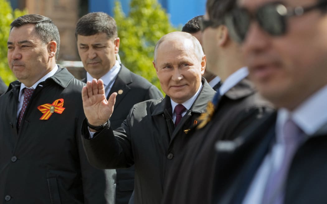 Russian President Vladimir Putin waves as he arrives for the Victory Day military parade at Red Square in central Moscow on May 9, 2023. Russia celebrates the 78th anniversary of the victory over Nazi Germany during World War II. (Photo by Yekaterina SHTUKINA / SPUTNIK / AFP)