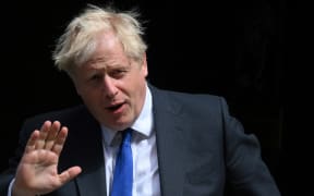 Britain's Prime Minister Boris Johnson waves as he leaves from 10 Downing Street  to head to the Houses of Parliament for the weekly Prime Minister's Questions (PMQs) session on 6 July 2022.