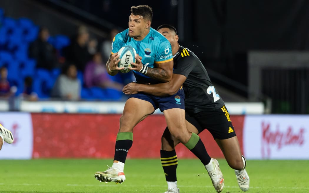 Moana Pasifika's Levi Aumua is tackled during the game against the Hurricanes at Mt Smart Stadium, Auckland