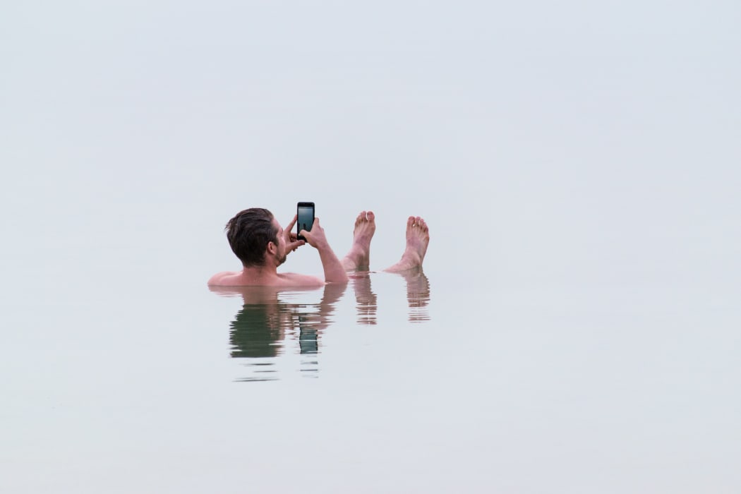 man on phone in sea