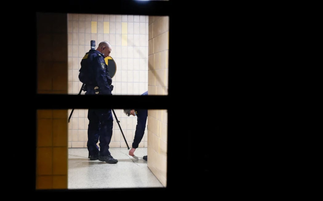 Police investigators at a crime scene in an apartment block in Soedertaelje, south of the Swedish capital Stockholm on 30 January.