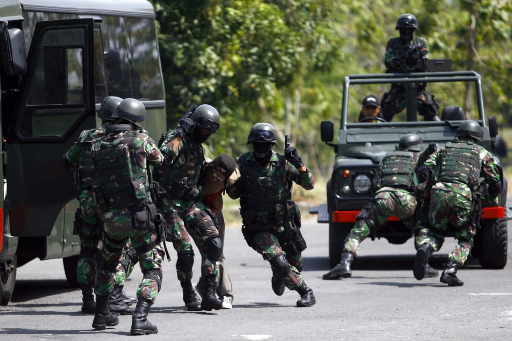Indonesia Army Special Forces soldiers (Kopassus) perform a quick attack during a simulated hostage bus hijacking drill in their headquarters complex in Kandang Menjangan, Sukoharjo, Central Java, Indonesia, on Monday, September 16, 2013.