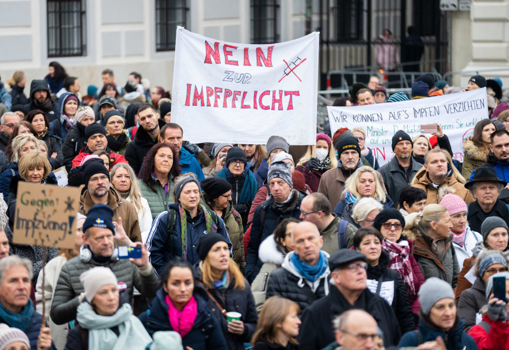 A demonstrator holds a placard reading 'No to compulsory vaccination' during an anti-vaccination protest at the Ballhausplatz in Vienna, Austria, on November 14, 2021.