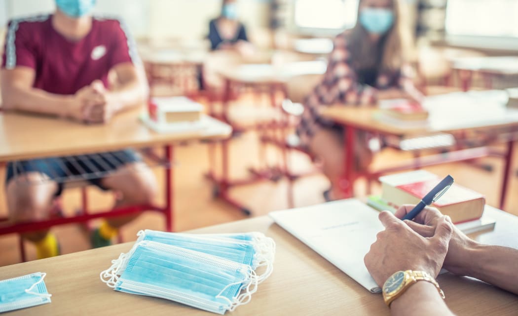 View from the teachers desk of students wearing protective masks against coronavirus disease.