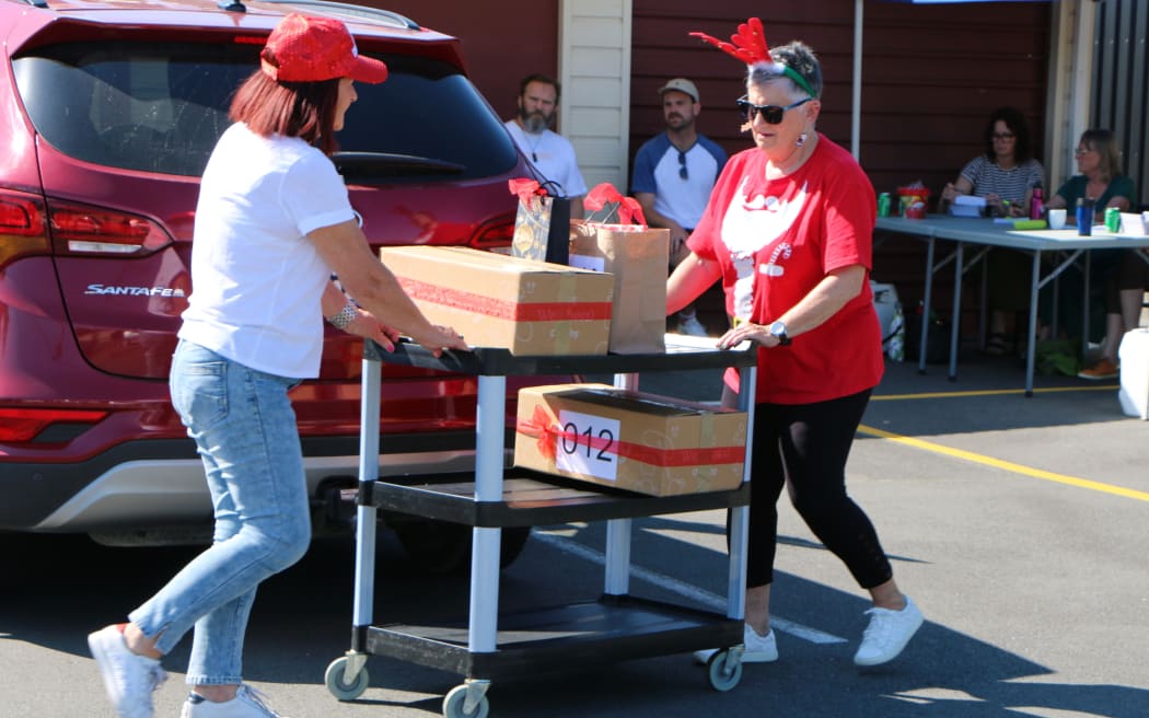 Christchurch Methodist Mission volunteers collect a donated Christmas hamper.