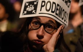 A supporter of left wing party Podemos grimaces during the Spain's general elections in Madrid on December 20, 2015. AFP PHOTO / TOPSHOTS / PEDRO ARMESTRE