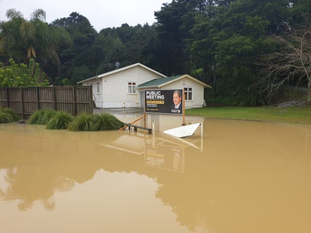 Northland flooding with a New Zealand First billboard.