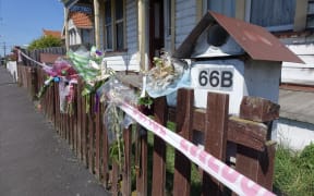 Bouquets line the fence of the Wesley property where the bodies of Anastasia Neve and David Clarke were found following their murders last week.