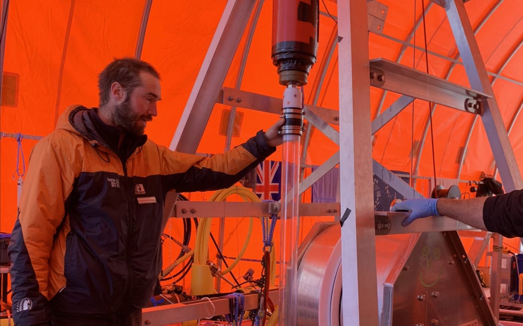 Martin Forbes, from the University of Otago, dropping a gravity corer through a hole made by using hot water to drill through 600 metres of ice.