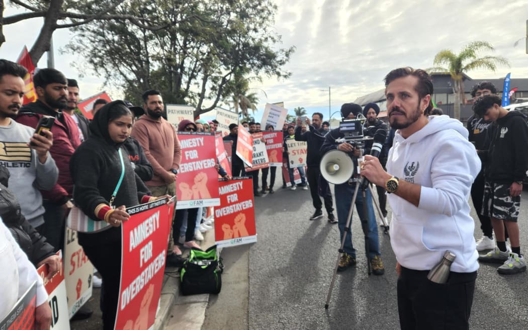 Sher Singh of the Migrant Rights Network addresses people at a protest against migrant worker exploitation, in Papatoetoe.