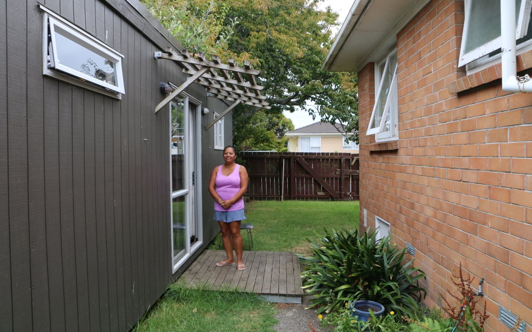 Aishai Bates-Hill in front of the cabin she has come to call home.