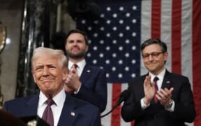 US Speaker of the House Mike Johnson (R-LA) and Vice President JD Vance applaud as US President Donald Trump arrives to address a joint session of Congress at the US Capitol in Washington, DC, on March 4, 2025. (Photo by Win McNamee / AFP)