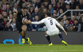 Codie Taylor runs the ball past Alex Mitchell of England during the England v All Blacks match, Allianz Stadium, Twickenham.