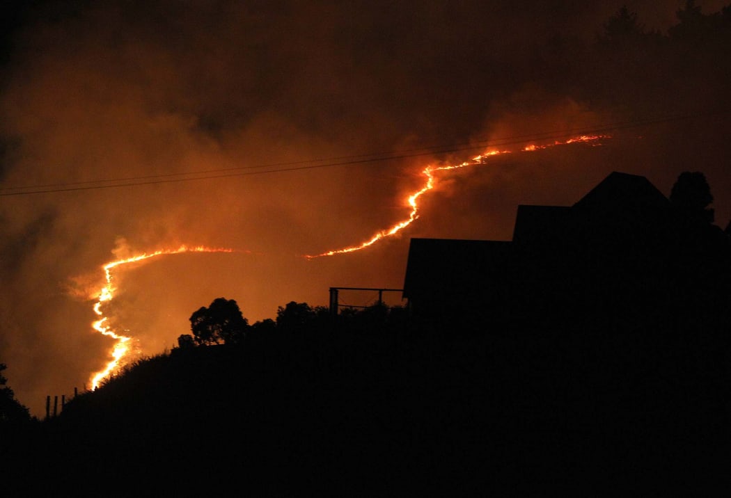 Joseph Johnson: A fire front around behind a Westmorland home stemming from the huge fire on the Port Hills.