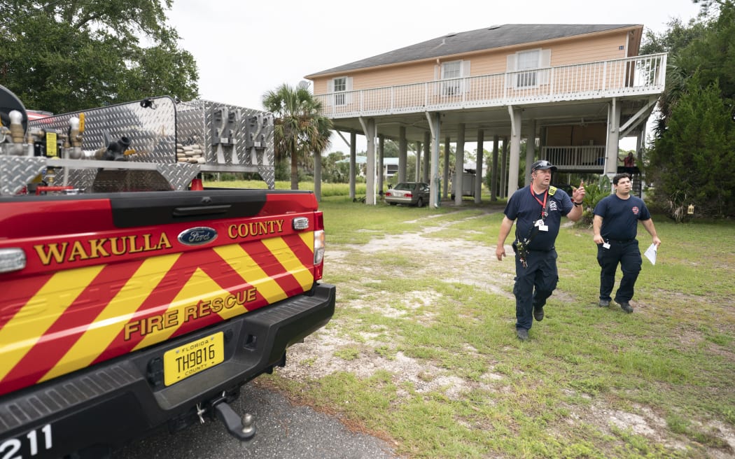 Wakulla County firefighters go door-to-door to take note of which residents plan to stay in their homes during Hurricane Helene on 25 September, 2024.