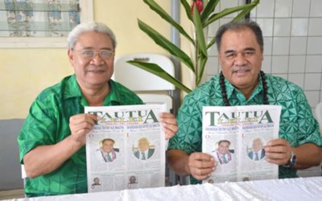 Tautua Samoa Party's Palusalue and Afualo holds up the Tautua Samoa Party newspaper