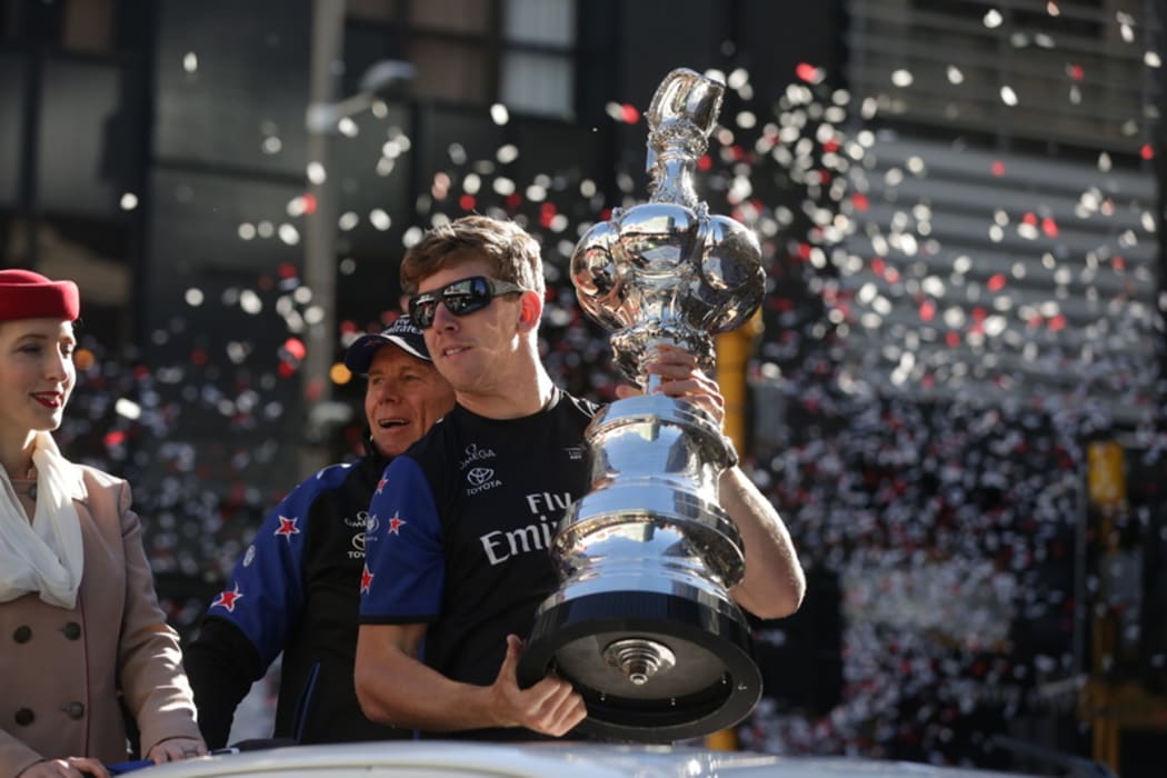 It's Wellington's turn to welcome the America's Cup today, with a parade through the central city. Peter Burling holds the cup.
