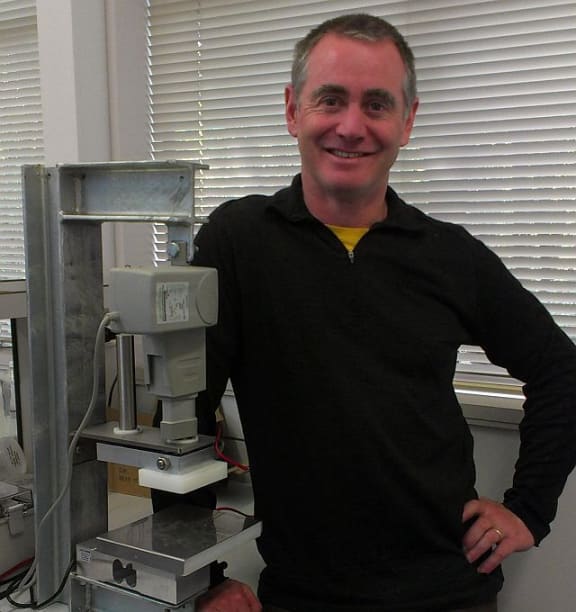 NIWA mechanical engineer Brendan Smith standing next to the mussel Crusher.