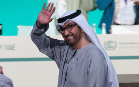 COP28 president Sultan Ahmed Al Jaber arrives for a plenary session during the United Nations climate summit in Dubai on December 13, 2023. A draft UN climate deal called on December 13 for the world to transition away from fossil fuels, in a last-ditch bid to break a deadlock between nations seeking a phase-out from oil, gas and coal and Saudi-led crude producers. (Photo by Giuseppe CACACE / AFP)