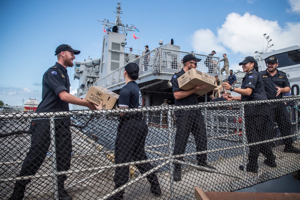Military personnel offload aid supplies in Fiji.