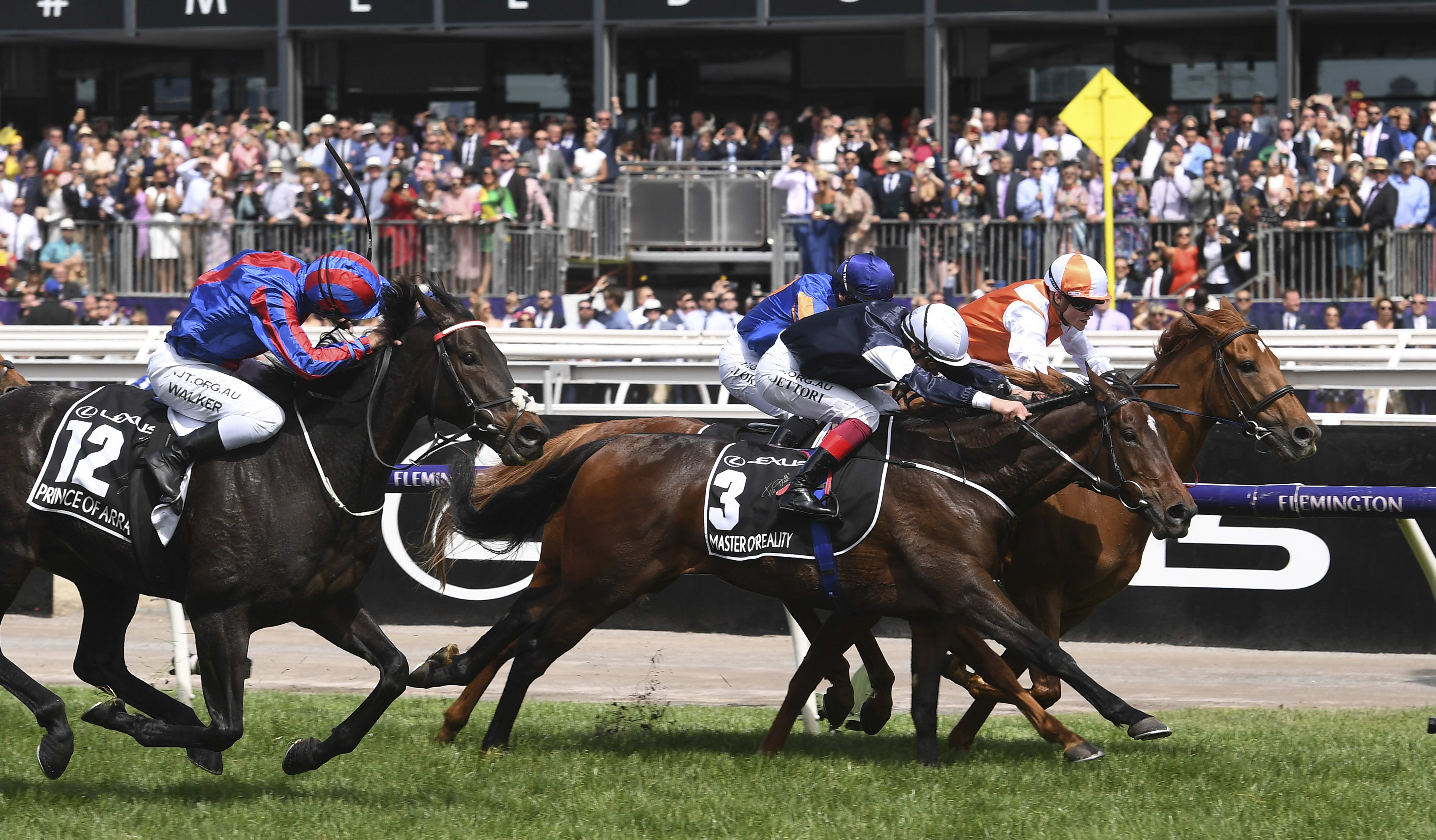 Jockey Craig Williams onboard Vow and Declare, followed by Frankie Dettori on Master of Reality and and at the far left, Michael Walker on Prince of Arran.