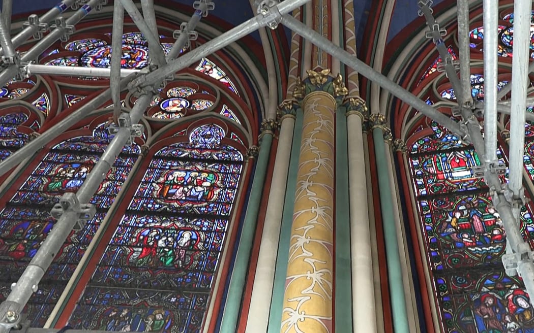 This video grab created from an AFP video taken on April 11, 2024, shows stained-glass windows inside Paris Notre-Dame cathedral under restoration since the devastating fire that ravaged it on April 15, 2019. A tender for the creation of contemporary stained-glass windows was launched on April 11, 2024. The iconic Parisian monument is scheduled to reopen in December 2024. (Photo by Mathilde BELLENGER / AFP)