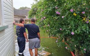 Floodwaters are pumped out of a home on Wairere Rd in Mount Albert by Fire and Emergency.