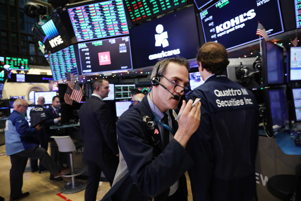 Traders work on the floor of the New York Stock Exchange (NYSE) on the last day of the trading year.