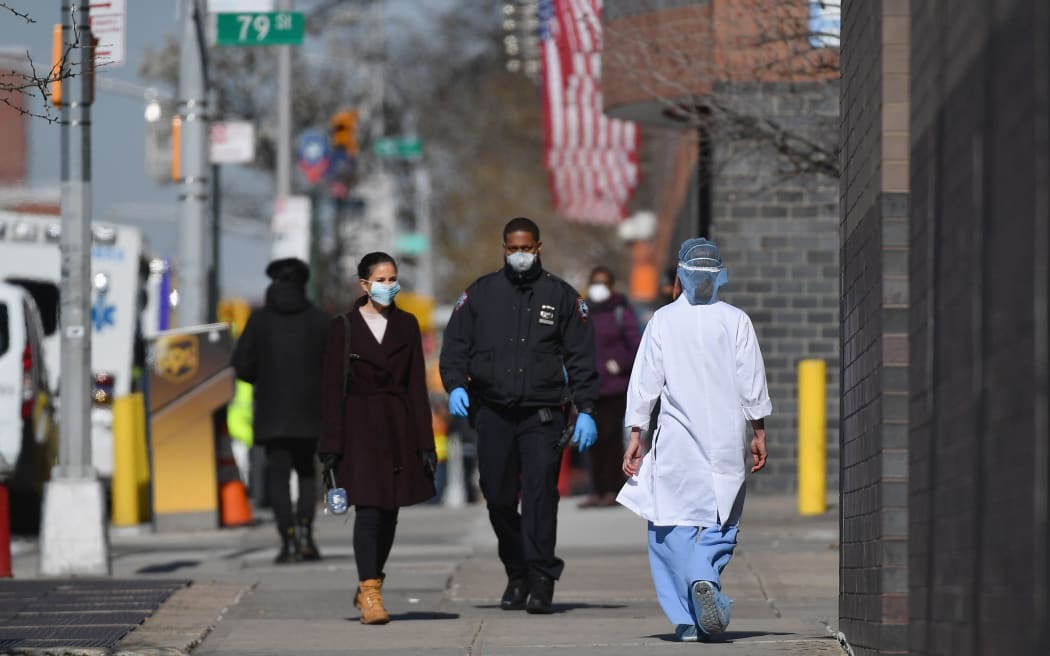 A medical worker outside the  Elmhurst Hospital Center in the Queens borough of New York City on 26 March 2020.
