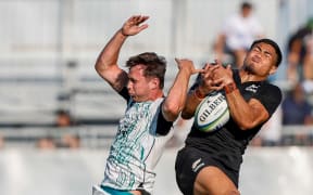 Ireland's Derry Moloney and New Zealand's Frank Vaenuku contest the high ball during the 2025 under-20 Rugby World Cup, Ireland.