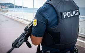 French police officer holding a gun (file photo).