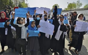 Afghan women and girls protesting in front of the Ministry of Education in Kabul, demanding schools be reopened for girls.