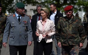 German Defence Minister Ursula von der Leyen (C) speaks with Inspector General of the German armed forces Bundeswehr Volker Wieker (R) and Inspector Heer General Joerg Vollmeer (L) during a visit at military facilities of the 291st Jagerbataillon in Illkirch-Graffenstaden, eastern France.