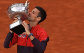 Serbia's Novak Djokovic kisses the trophy as he celebrates his victory over Norway's Casper Ruud in the men's singles final at the 2023 French Open.
