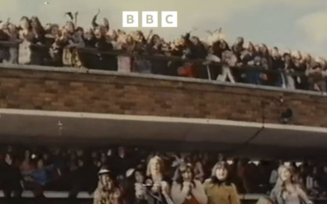 Fans wait for The Osmonds on the viewing balcony at Heathrow Airport before the collapse
