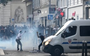 Protesters clash with CRS riot police in Marseille, southern France on June 30, 2023, over the shooting of a teenage driver by French police in a Paris suburb on June 27. The unrest has come in response to the killing of 17-year-old Nahel, whose death has revived longstanding grievances about policing and racial profiling in France's low-income and multi-ethnic suburbs. (Photo by CHRISTOPHE SIMON / AFP)