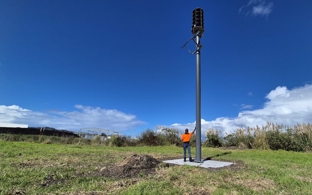 Northland tsunami siren replacement project construction manager Tawanda Shiri with siren 21 that's taking shape at Whangārei's Port Nikau
(Photo by Susan Botting Local Democracy Reporter Northland PLEASE CREDIT)
