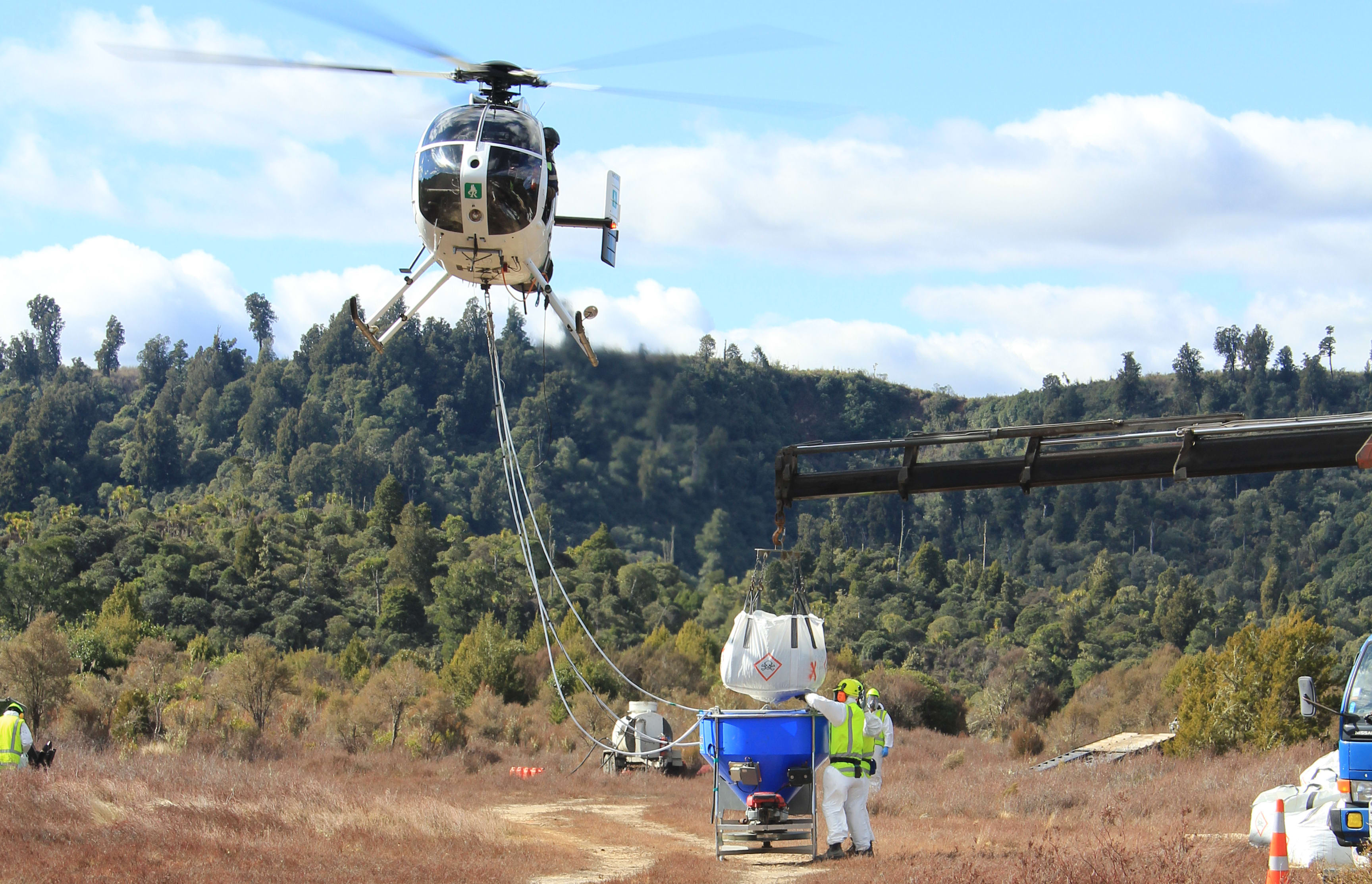 A bait bucket being refilled during an aerial 1080 operation in the Tongariro Conservation Area